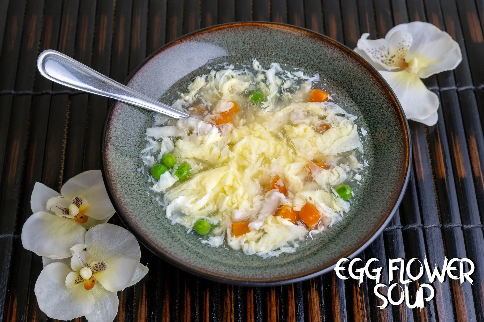 Egg Flower Soup - Clear soup with egg ribbons, peas, and carrots at Chef Panda, a Chinese restaurant in Surprise