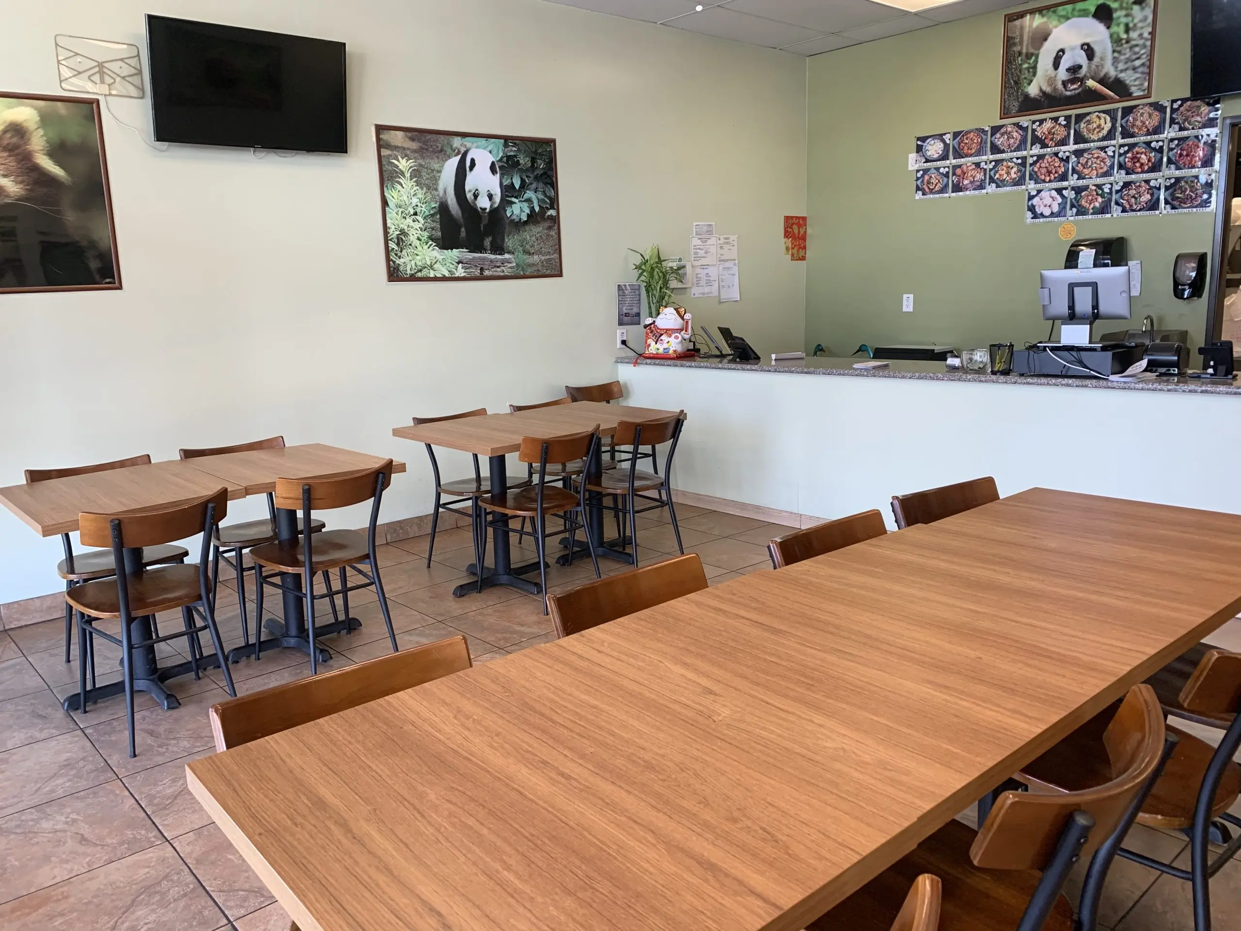 Neat dining area with wooden tables, chairs, and panda decor at Chef Panda, a Chinese Restaurant in Surprise
